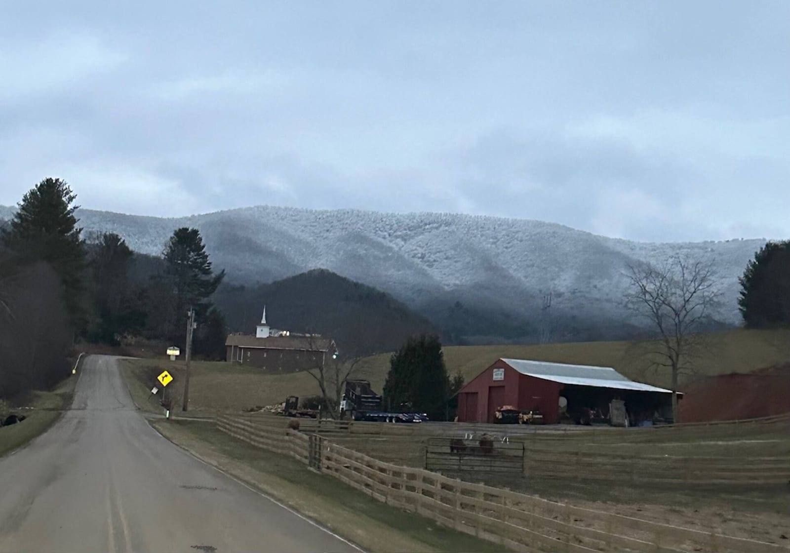 Snow-covered mountains above Watauga Lake on a clear winter day.